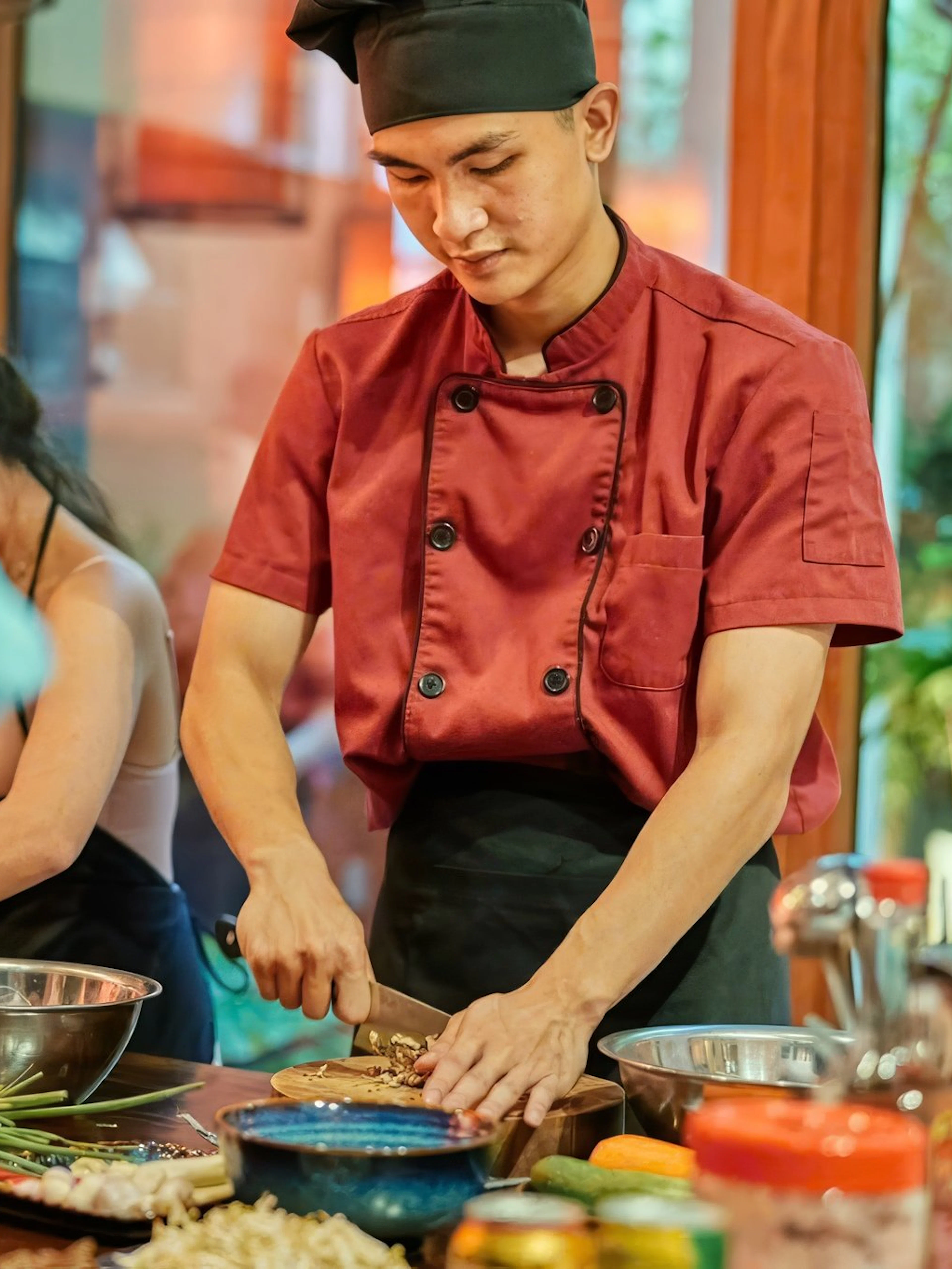 Chef preparing ingredients in a traditional Vietnamese cooking class.