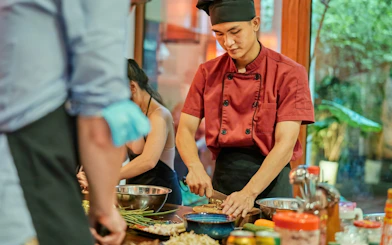 Chef preparing ingredients in a traditional Vietnamese cooking class.