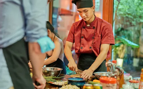 Chef preparing ingredients in a traditional Vietnamese cooking class.