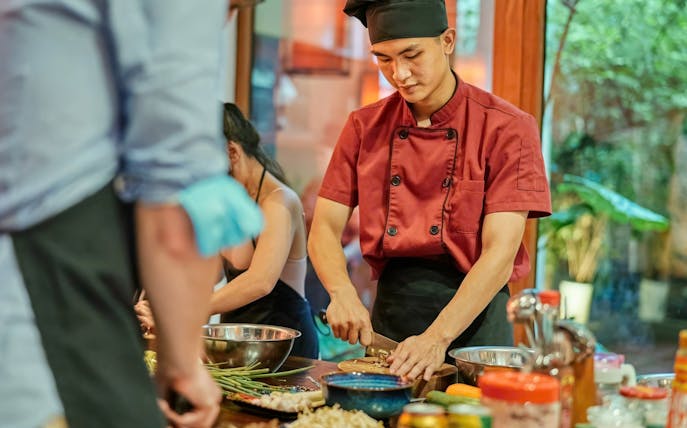 Chef preparing ingredients in a traditional Vietnamese cooking class.