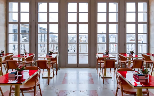 Lunch tables at Illy Cafe with views of Royal Gardens through large windows.