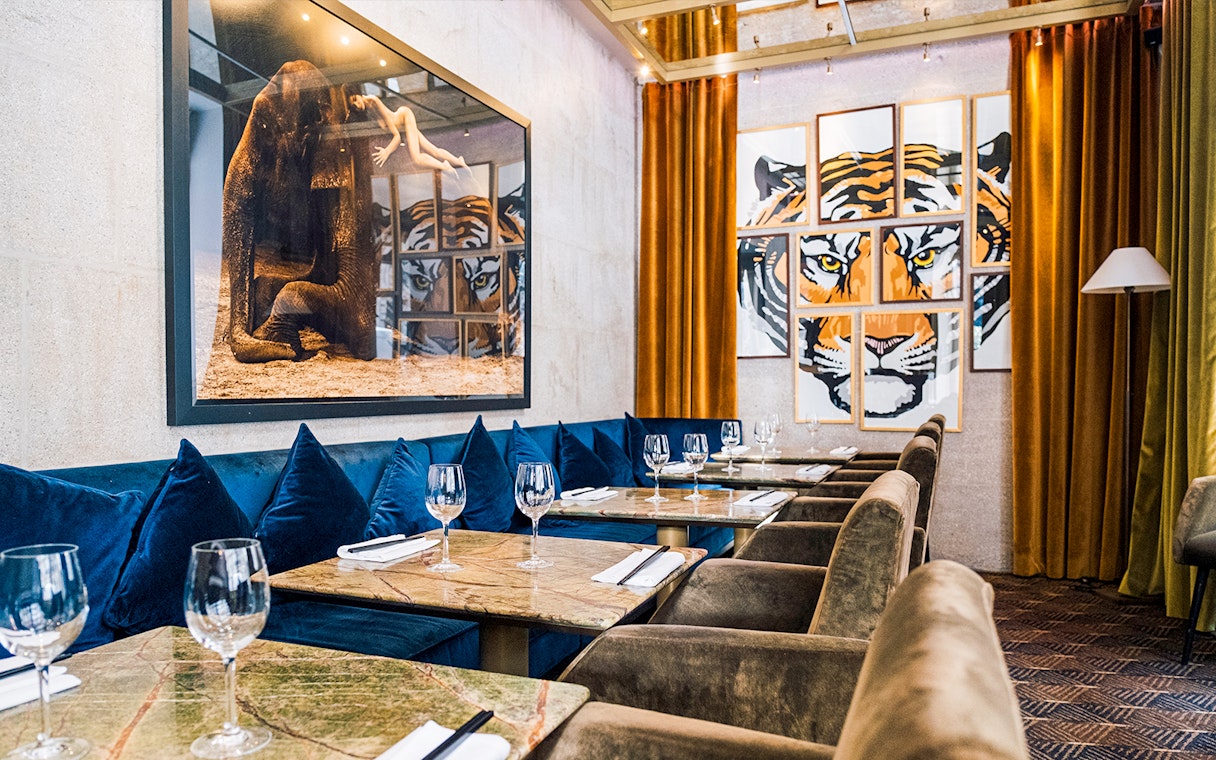 Dining area with art decor at Crazy Horse Paris Show and Dinner.