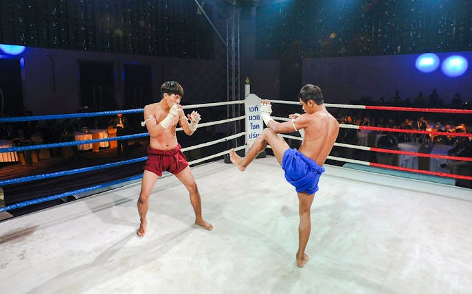 Muay Thai fighters in a ring during a Max Muay Thai event in Thailand.