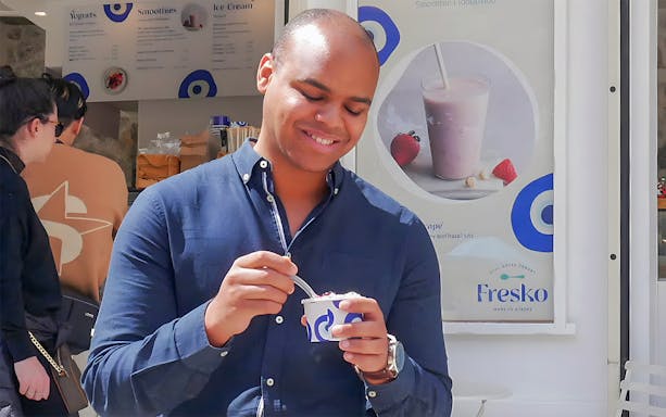 Man enjoying yogurt at Fresko in Athens Old Town.