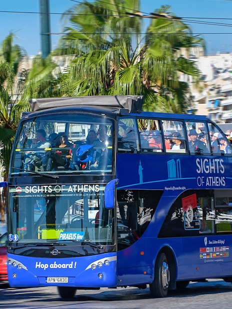 Open-top bus touring Athens with views of the Acropolis, Piraeus, and nearby beaches.