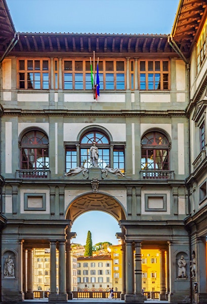 Uffizi Gallery courtyard with statues and arches, Florence, Italy.