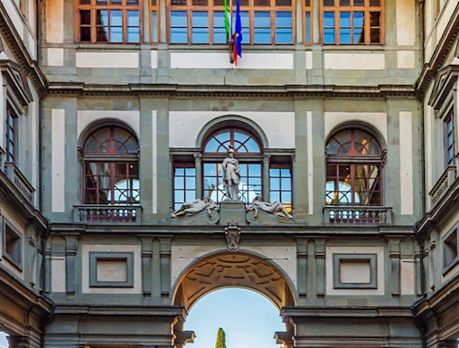 Uffizi Gallery courtyard with statues and arches, Florence, Italy.