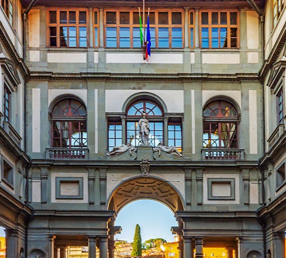 Uffizi Gallery courtyard with statues and arches, Florence, Italy.