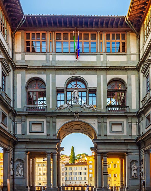 Uffizi Gallery courtyard with statues and arches, Florence, Italy.
