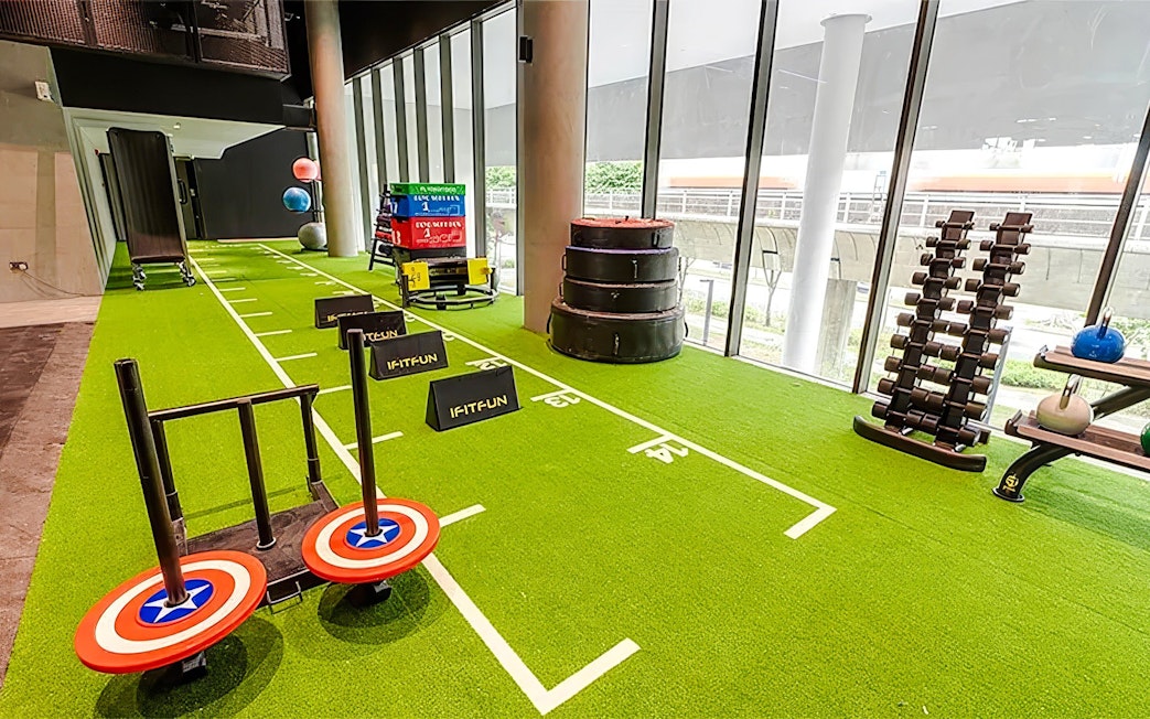 Running track with hurdles and fitness equipment inside T-Play Khatib.