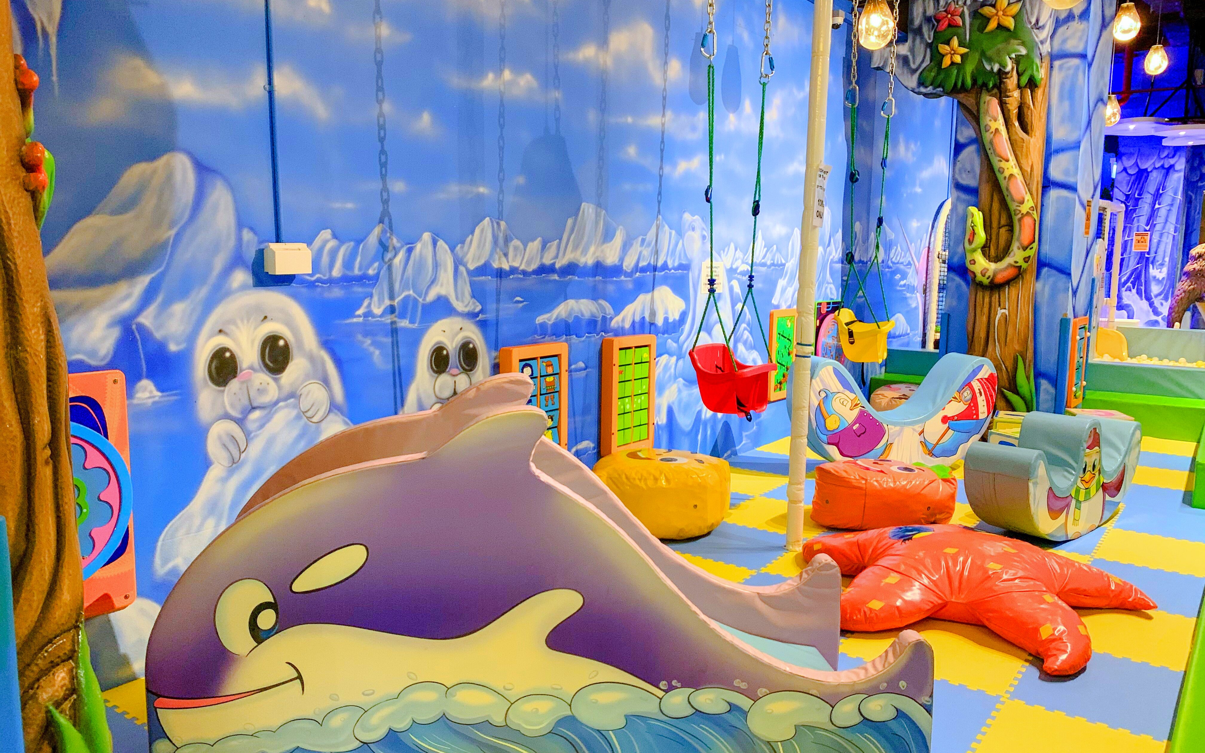 Indoor playground with ocean-themed decor and swings at Amazonia Singapore.