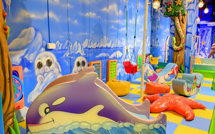 Indoor playground with ocean-themed decor and swings at Amazonia Singapore.