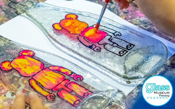 Glass painting activity at Glass Museum Penang featuring colorful bear designs.