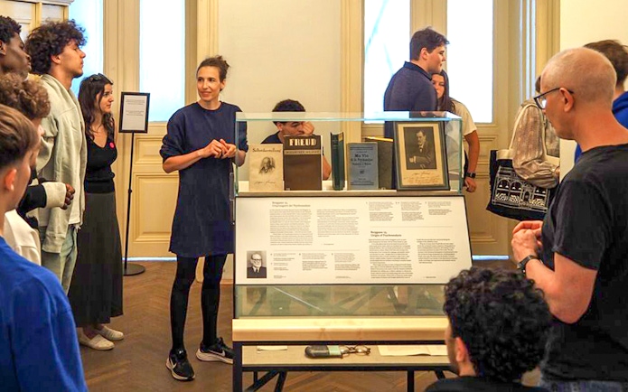 Tour group with female guide at Sigmund Freud Museum, Vienna, Austria.
