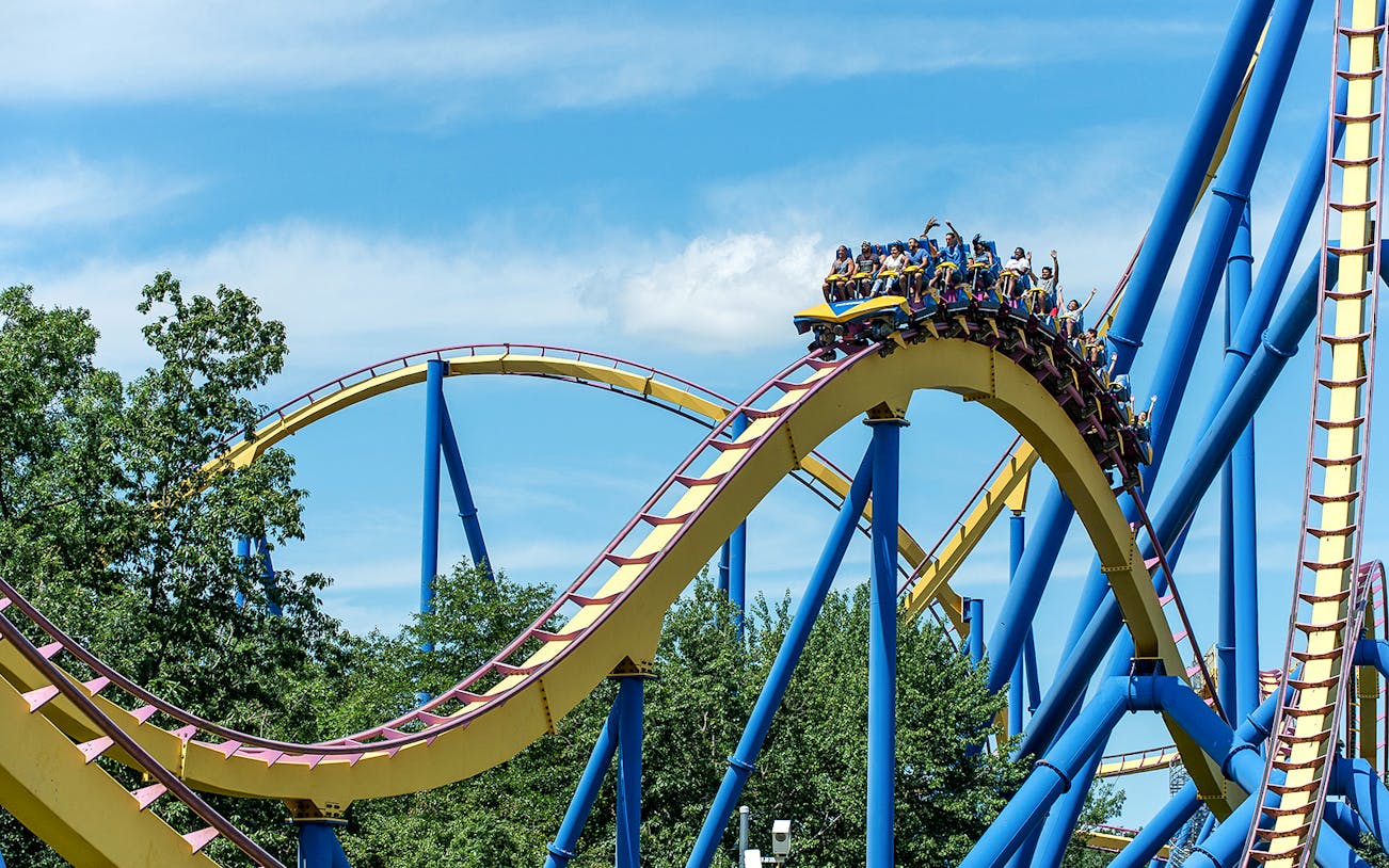 Roller coaster at Six Flags Great Adventure with riders on a loop.