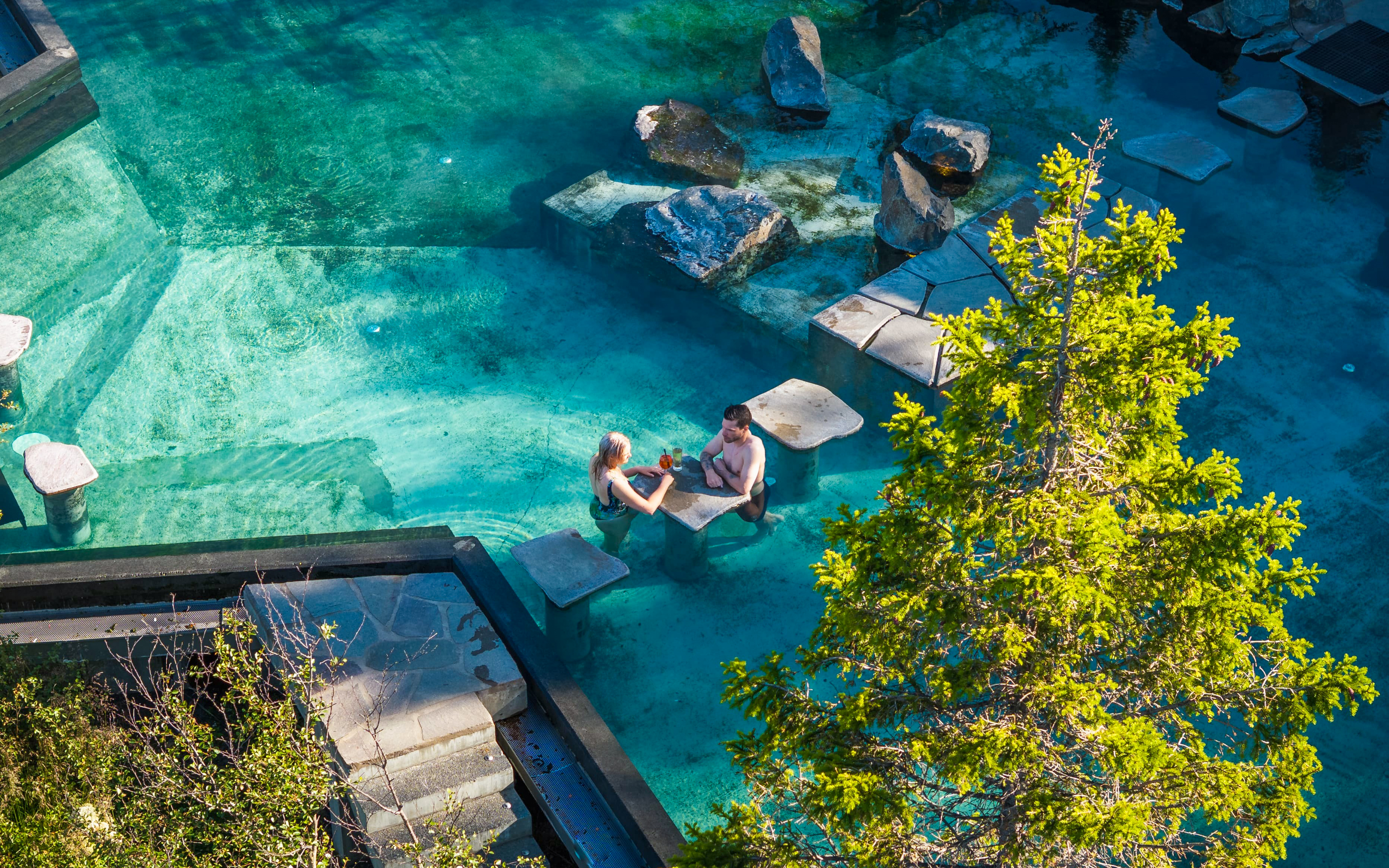 Couple relaxing in Forest Lagoon geothermal spa, Vaðlaskógur forest, near Akureyri, North Iceland.