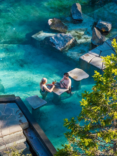 Couple relaxing in Forest Lagoon geothermal spa, Vaðlaskógur forest, near Akureyri, North Iceland.