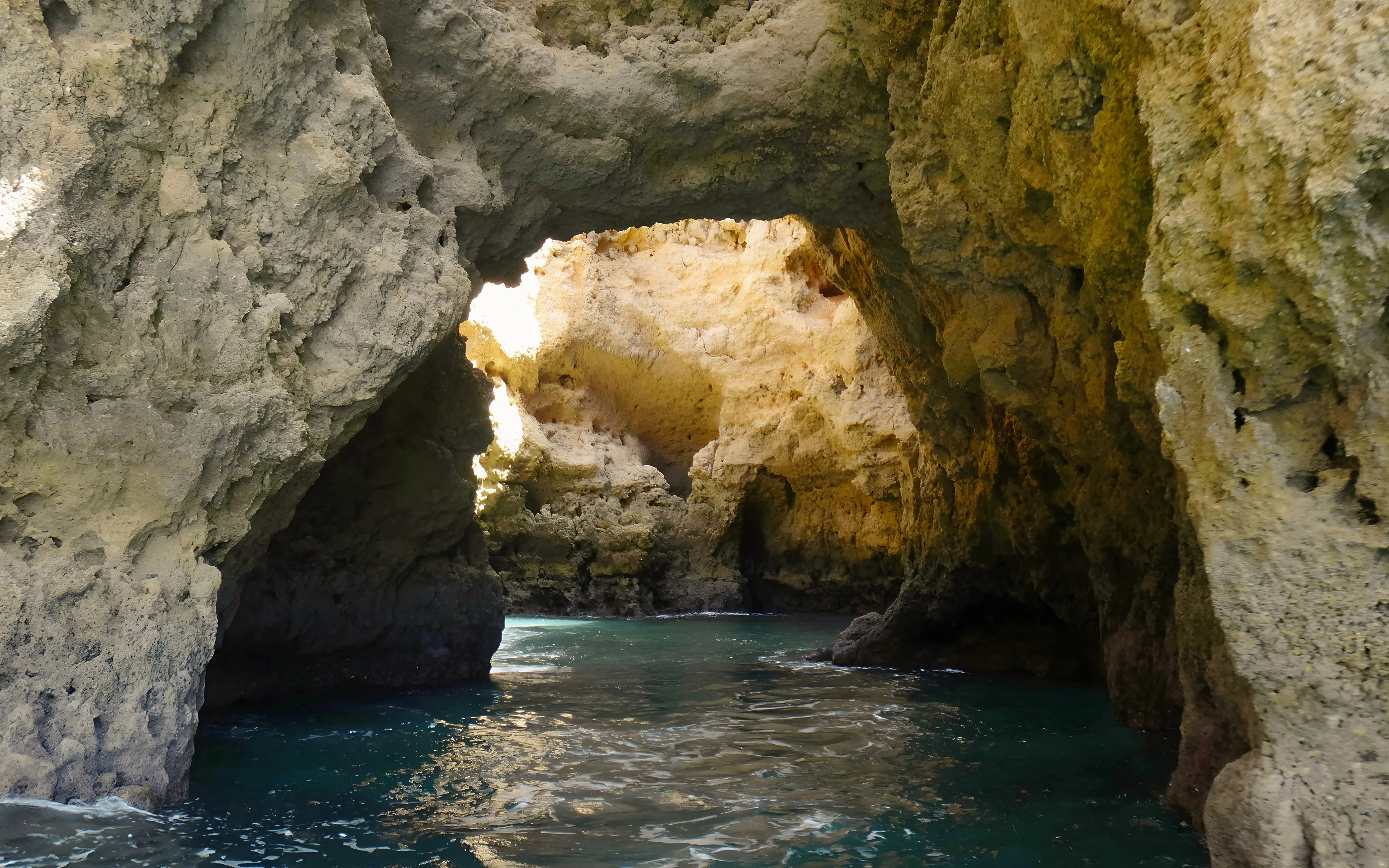 Caves of Ponta da Piedade with turquoise water on a private cruise in Lagos, Portugal.
