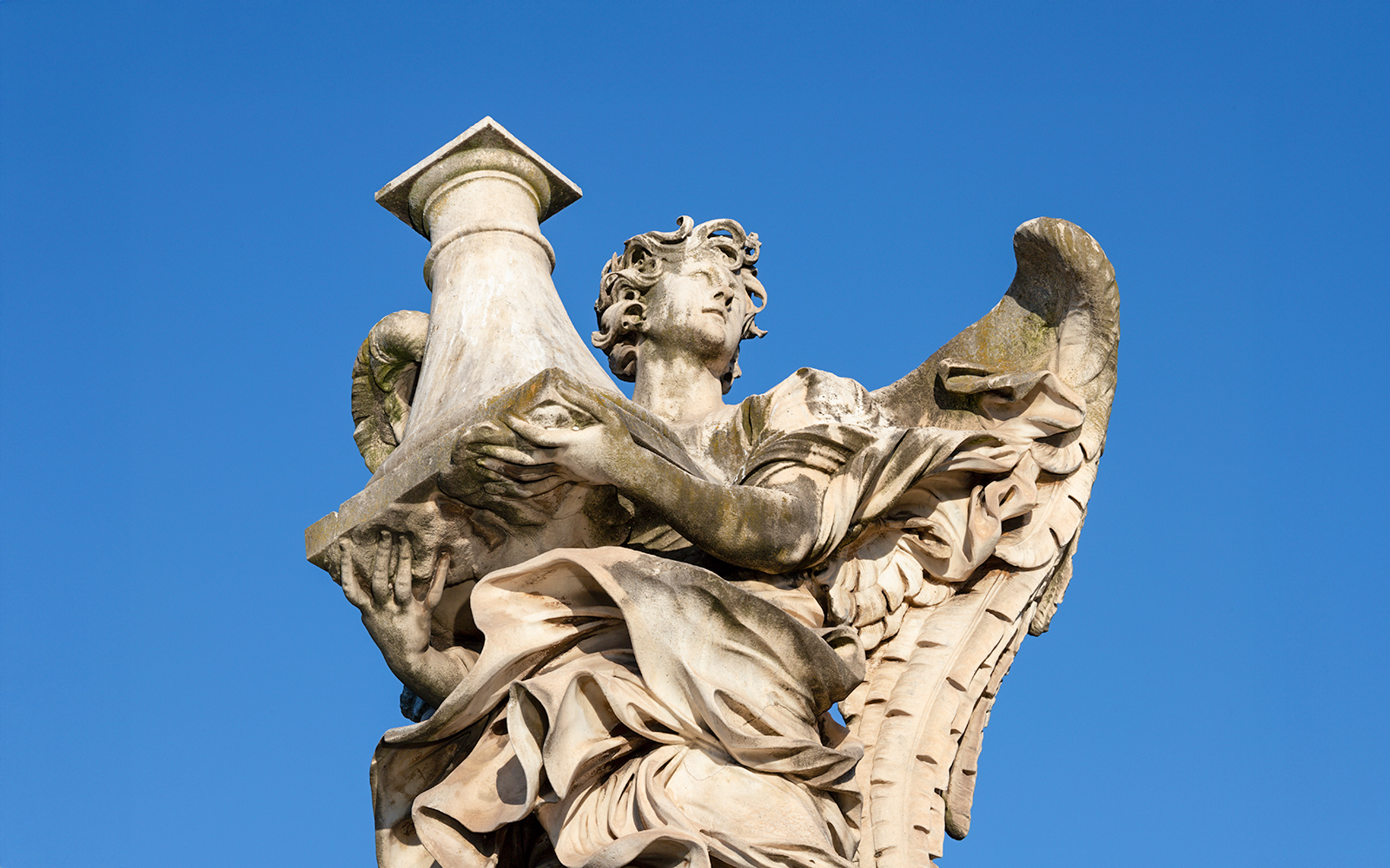 Angel statue by Antonio Raggi holding a column on Ponte Sant'Angelo, Rome.