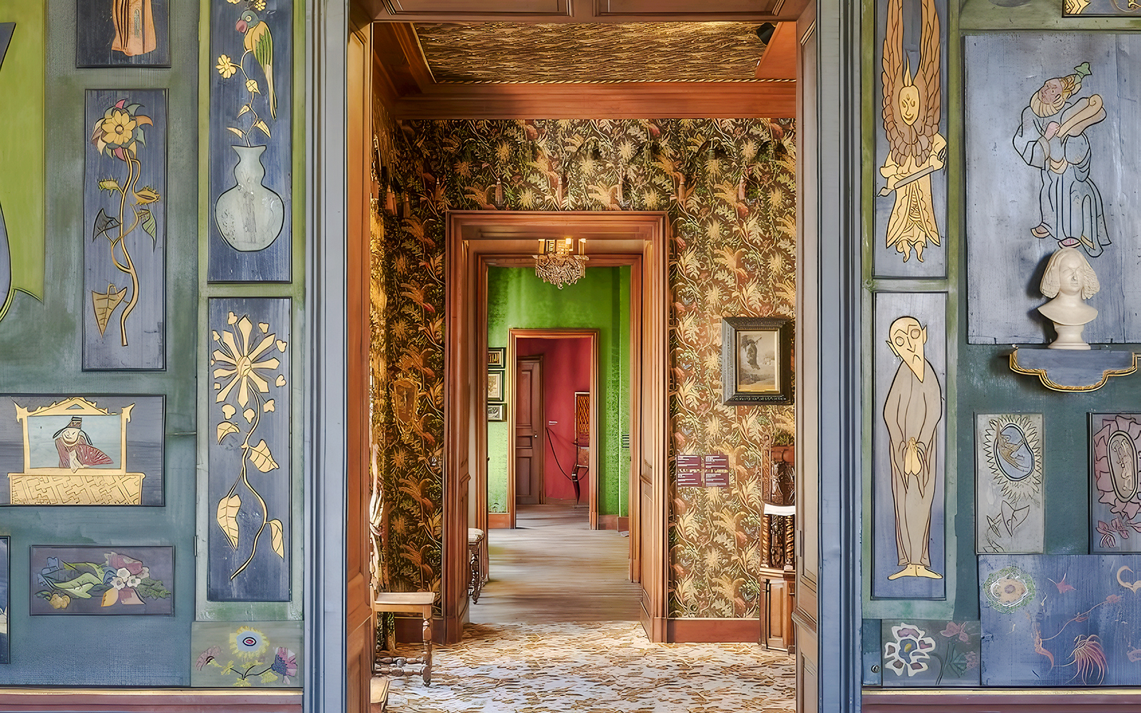 Interior hallway of The Victor Hugo House in Paris, featuring ornate wall art and vibrant decor.