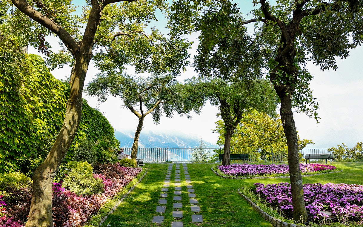 Garden path with flowers and trees at Principessa di Piemonte, overlooking the Amalfi Coast, Ravello, Italy.