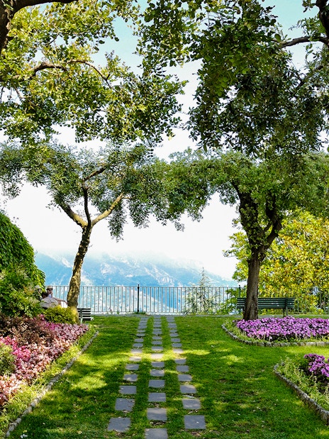 Garden path with flowers and trees at Principessa di Piemonte, overlooking the Amalfi Coast, Ravello, Italy.