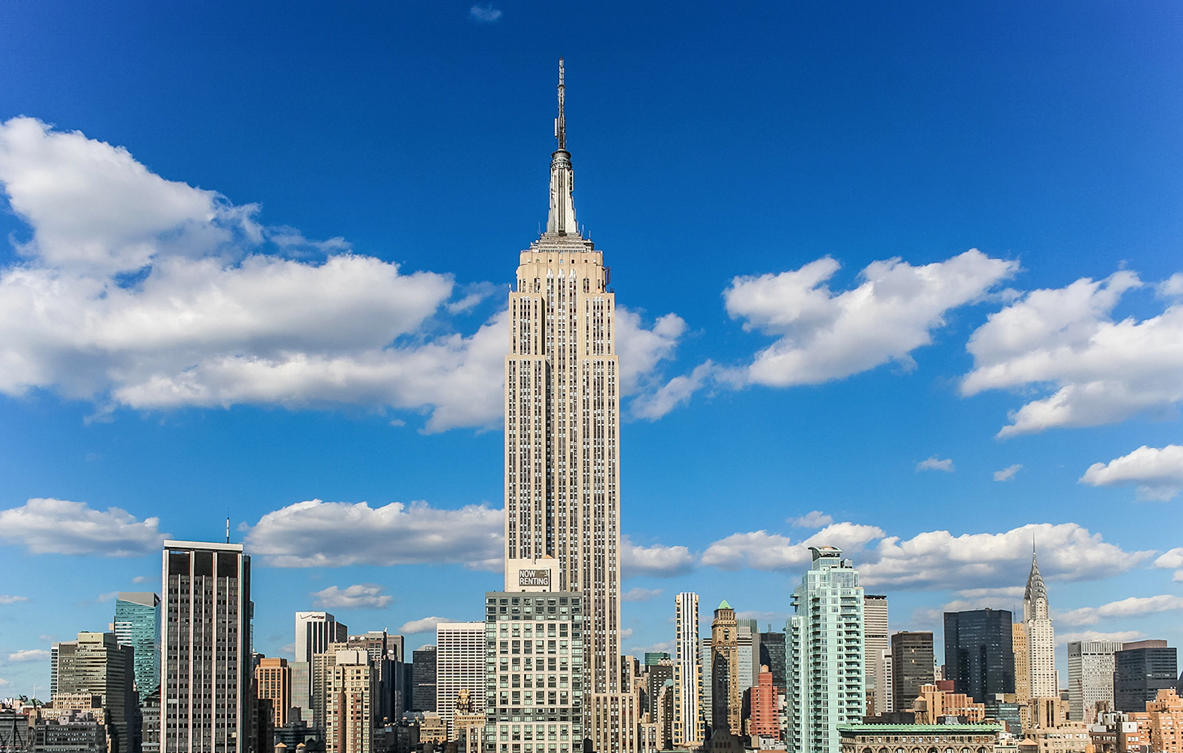Empire State Building against a blue sky in New York City.