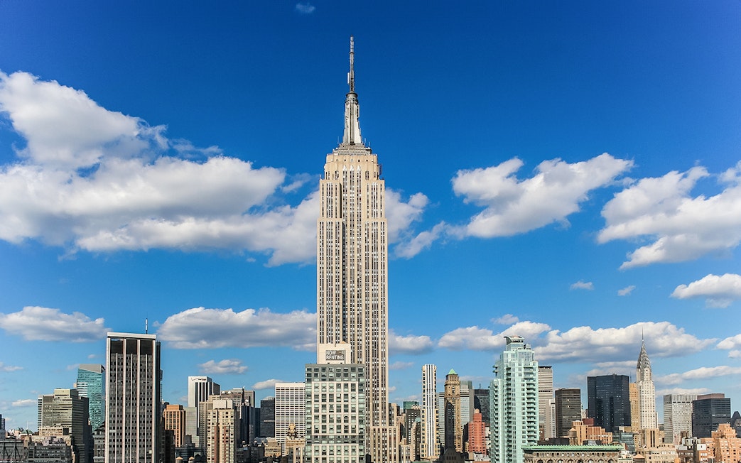 Empire State Building against a blue sky in New York City.