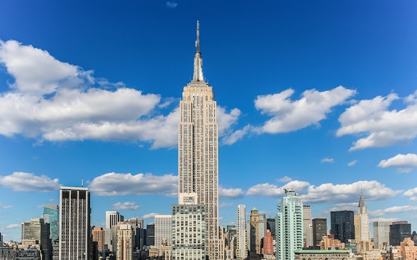 Empire State Building against a blue sky in New York City.