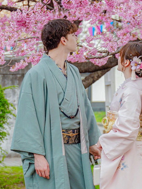 Couple in Yukata under cherry blossoms in Japan.