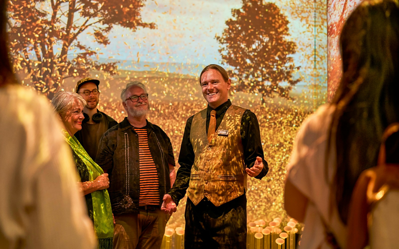 Guide leading visitors on a sensory journey through Scotland with autumn backdrop.