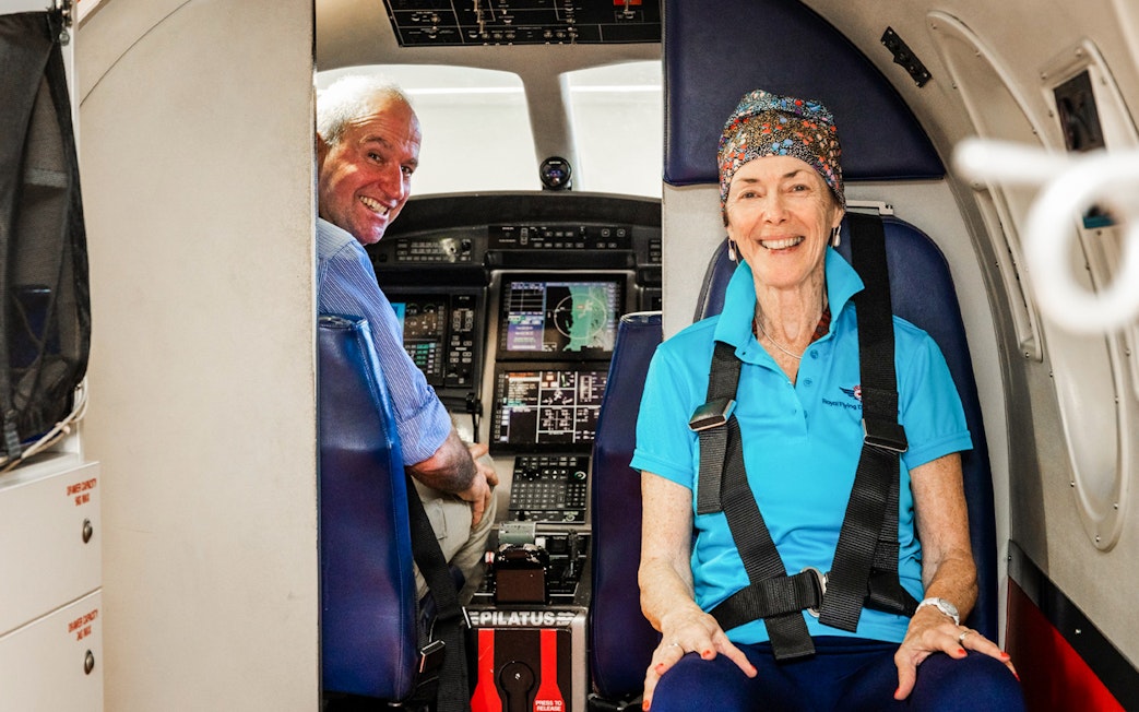 Pilot and passenger inside Royal Flying Doctor Service aircraft cockpit, Alice Springs.