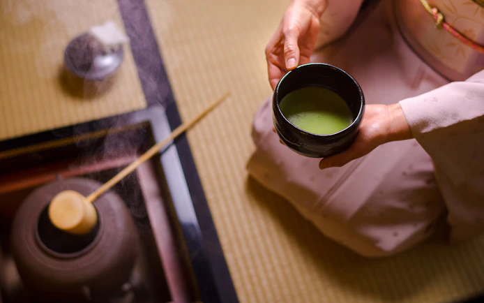 Preparing matcha tea in a traditional Japanese setting in Tokyo.