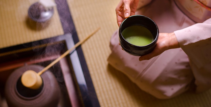 Preparing matcha tea in a traditional Japanese setting in Tokyo.