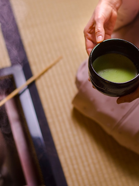 Preparing matcha tea in a traditional Japanese setting in Tokyo.