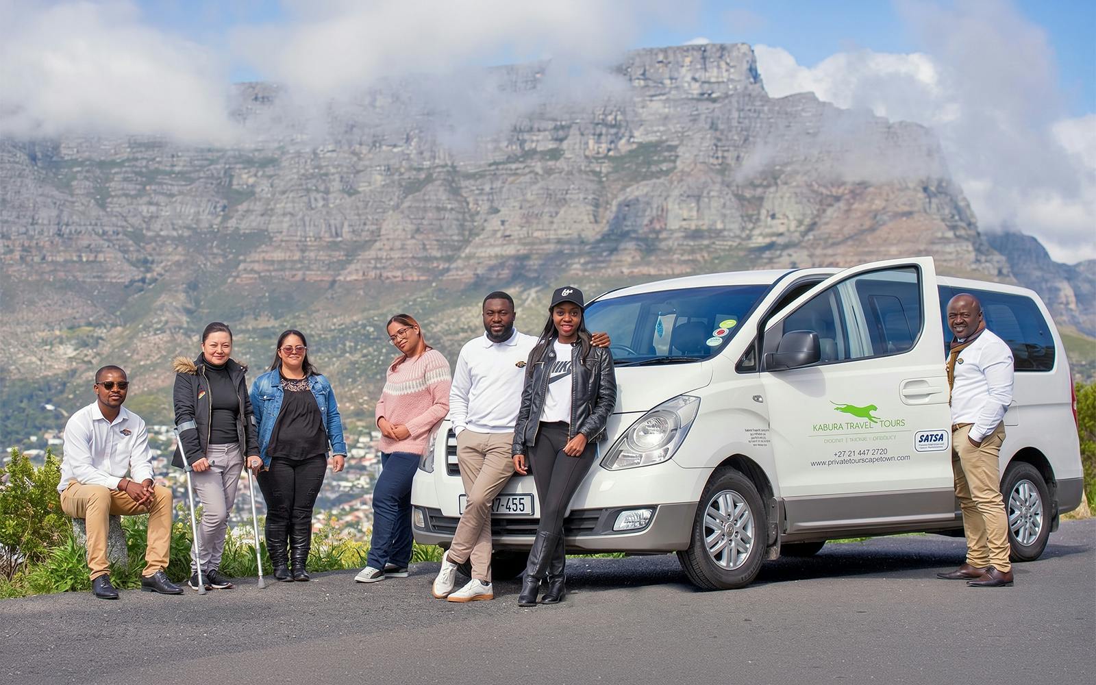 Tour group with van in front of Table Mountain, Cape Town.