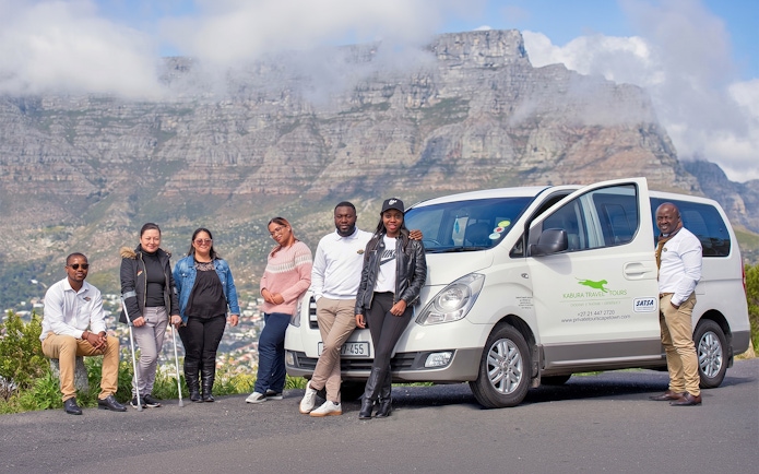 Tour group with van in front of Table Mountain, Cape Town.