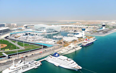 Yas Marina Circuit aerial view with yachts and modern architecture in Abu Dhabi.