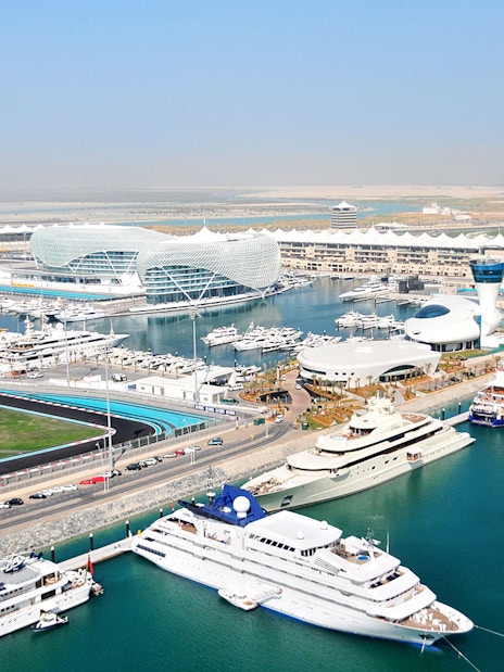 Yas Marina Circuit aerial view with yachts and modern architecture in Abu Dhabi.
