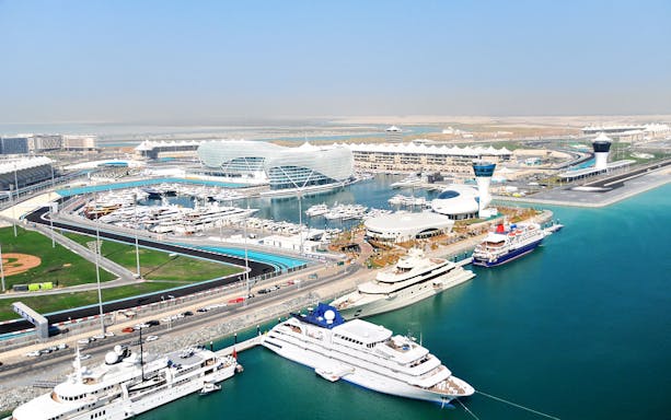Yas Marina Circuit aerial view with yachts and modern architecture in Abu Dhabi.