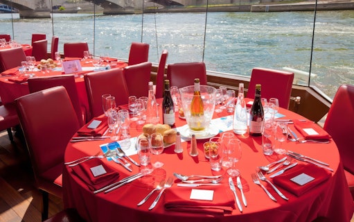Elegant table setting on a river cruise for Valentine's Day dinner, featuring wine and bread.