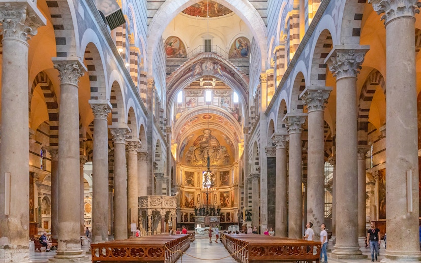 Pisa Cathedral interior with ornate columns and detailed frescoes.