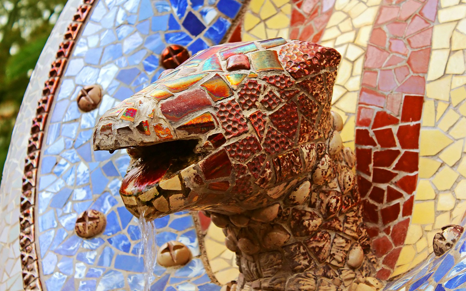 Park Guell Dragon sculpture in Barcelona's mosaic-covered terrace.