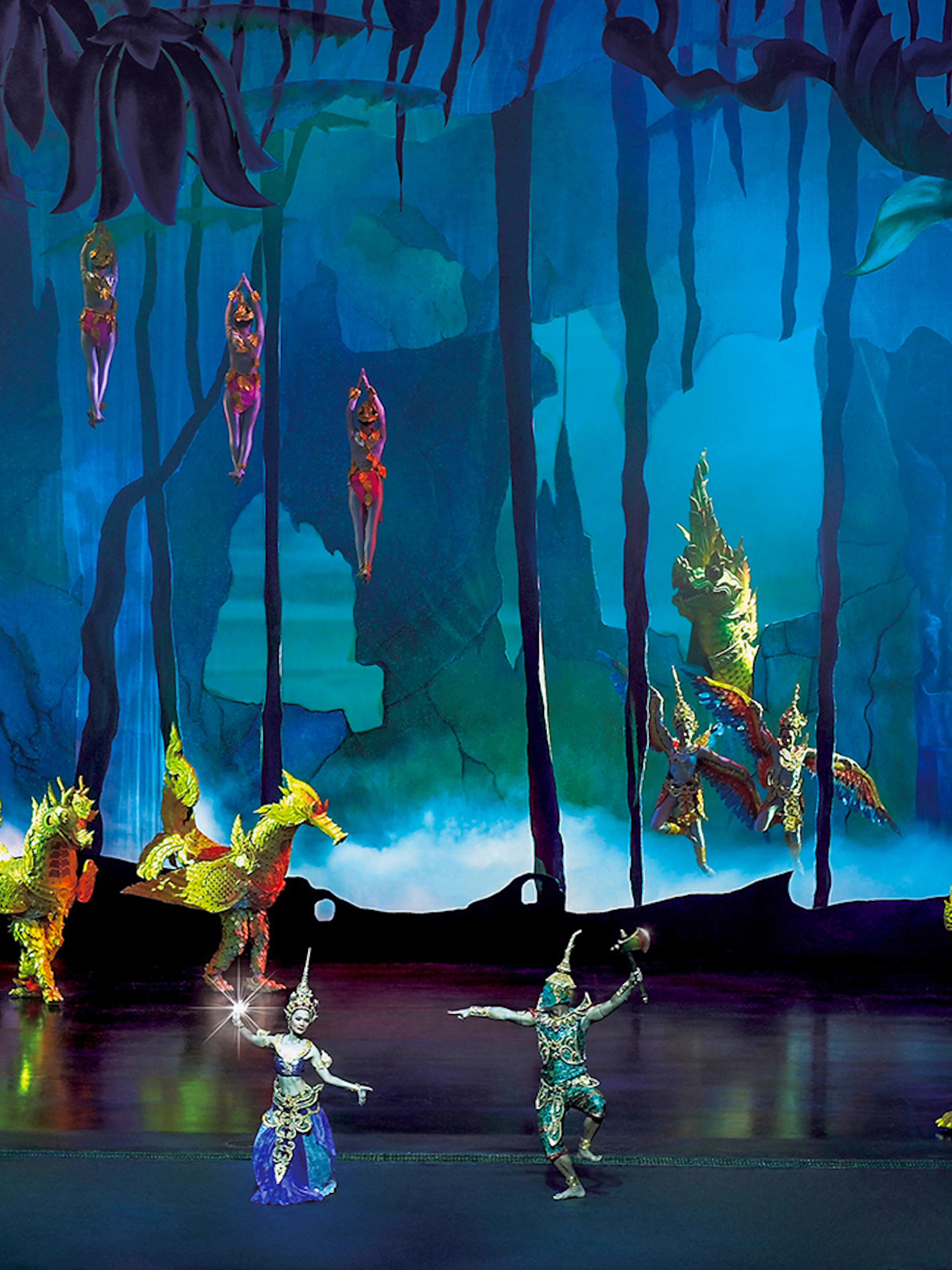 Performers in traditional costumes on stage at Siam Niramit Phuket show.