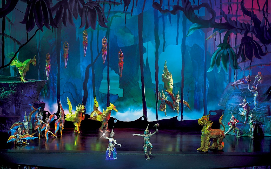 Performers in traditional costumes on stage at Siam Niramit Phuket show.