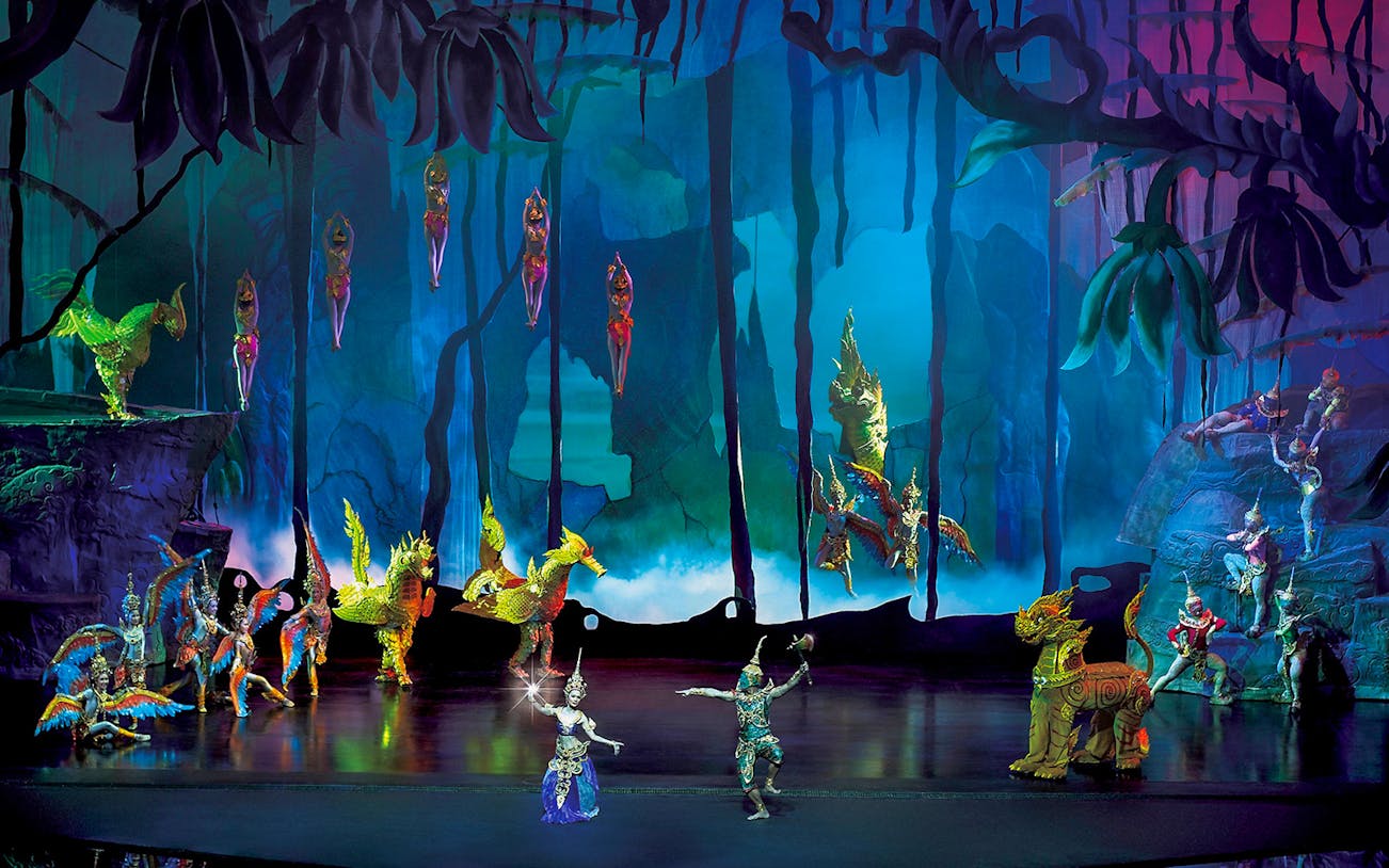 Performers in traditional costumes on stage at Siam Niramit Phuket show.