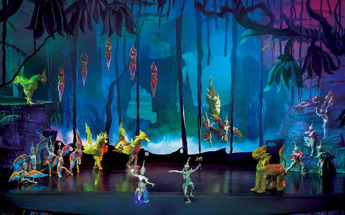 Performers in traditional costumes on stage at Siam Niramit Phuket show.