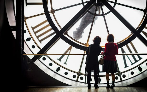 Visitors view Paris through the Musée d'Orsay clock during the Impressionism tour.
