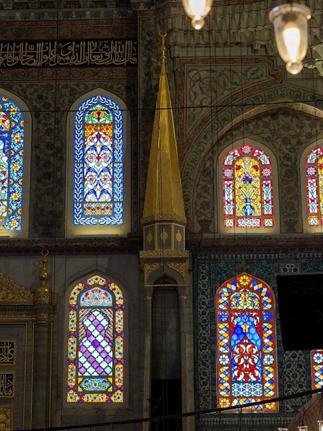 Stained glass windows inside Hagia Sophia, Istanbul, showcasing intricate patterns and vibrant colors.