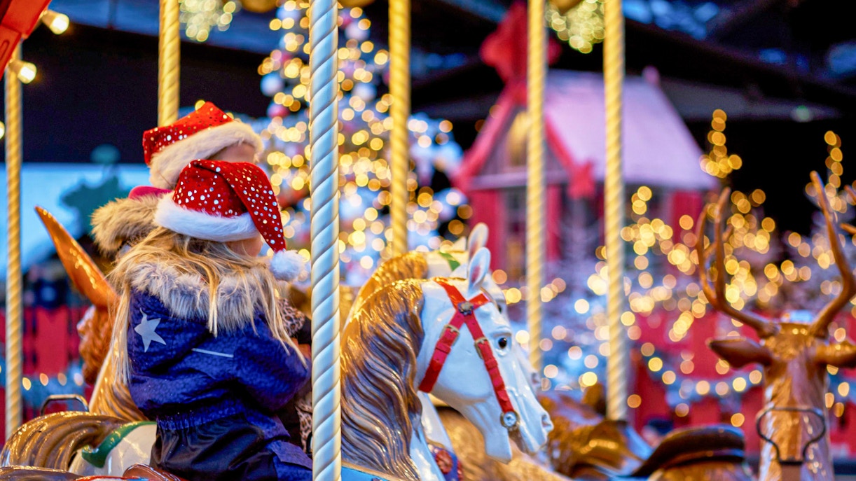 Children on a carousel at Tivoli Gardens during Christmas.